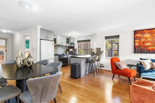 a kitchen and living room with a table and chairs at The Bishops Escape A Sepal Stay in Perth
