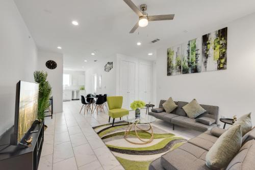 a living room with a couch and a tv at City View 2BR Apartments in Dallas
