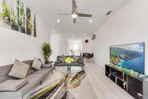 a living room with a couch and a tv at City View 2BR Apartments in Dallas