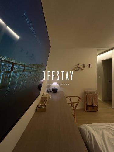 a bedroom with a large tv on the wall at OFF STAY, hotel in Seoul - 10m from Airport, 8m to Subway in Seoul