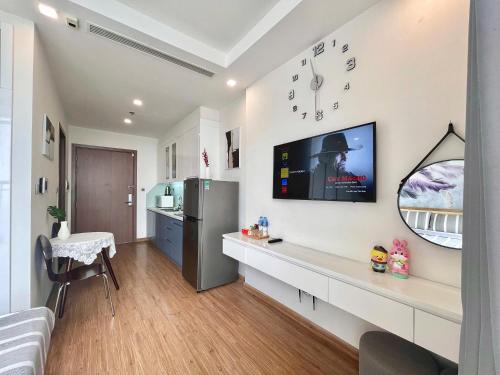 a living room with a television on a wall at Lux Studio Apt In Vinhomes Convenient To Airport in Hanoi