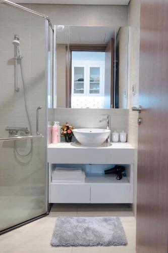 a bathroom with a sink and a shower at Lux Studio Apt In Vinhomes Convenient To Airport in Hanoi