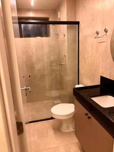 a bathroom with a shower with a toilet and a sink at Encanto Moanara in Luis Correia