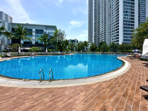 a large swimming pool in a city with tall buildings at Lux Studio Apt In Vinhomes Convenient To Airport in Hanoi