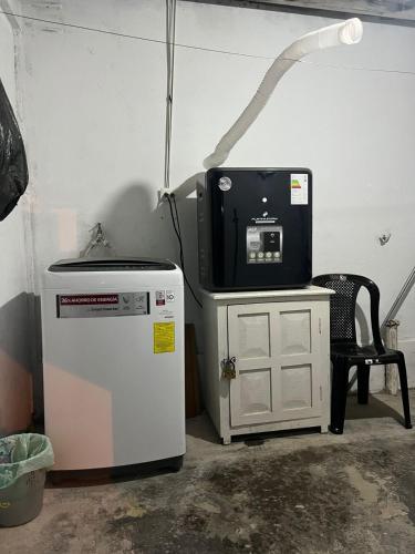 a room with a television and a small refrigerator at Sierra Nevada Premium in Ibarra