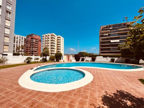 a swimming pool in the middle of a building at Calpe apartamento LuXurY nuevo playa centrico parking wifi aire piscina patio in Calpe