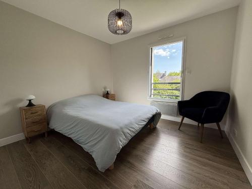 a bedroom with a bed and a chair and a window at Maison charmante, proche plages de l'Ile-Tudy, calme garanti - FR-1-481-180 in Combrit