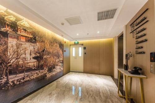 a hallway with a large painting on the wall at Atour Hotel Beijing Zhongguancun Life Science Park in Yongfengtun