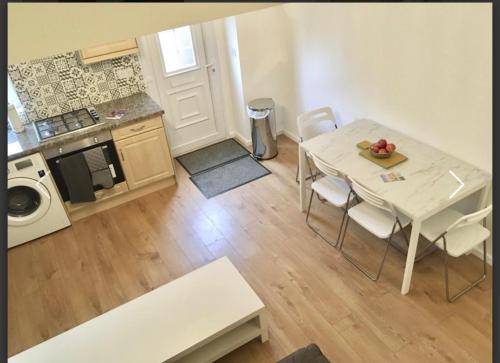 a small kitchen with a table and chairs in a room at Living Stone 1 Room in Kent