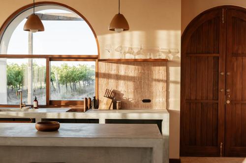 a kitchen with a sink and a large window at Clay - Rare Earth Retreats in McLaren Vale