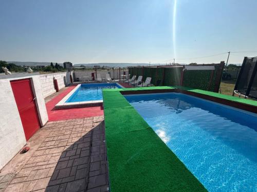 two swimming pools on top of a building at Neiras Apartments Blagaj in Blagaj