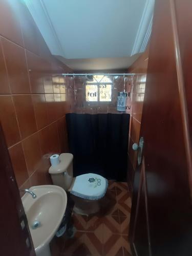 a small bathroom with a toilet and a sink at Residence Efrata Casa Inteira in Itaboraí