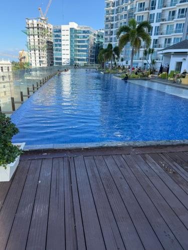 a large swimming pool in a city with buildings at 8 Newtown Mactan Condominium in Lapu Lapu City