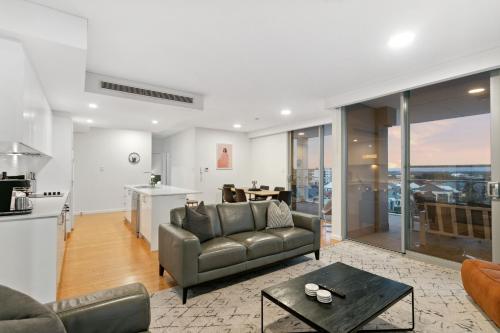 a living room with a couch and a table at EAST34 - Skyline Haven East Perth in Perth