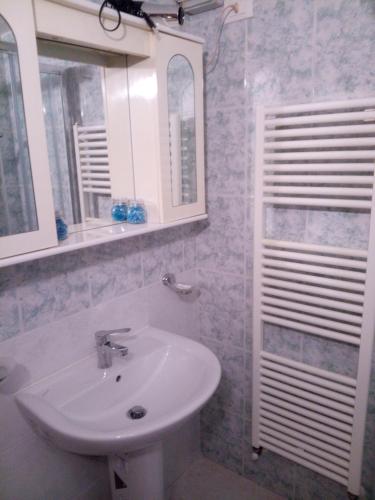 a bathroom with a white sink and a mirror at Le case di Tiberio in Assisi
