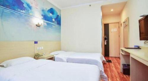 a hotel room with two beds and a counter at Super 8 Hotel Jinan Railway Station Square in Jinan