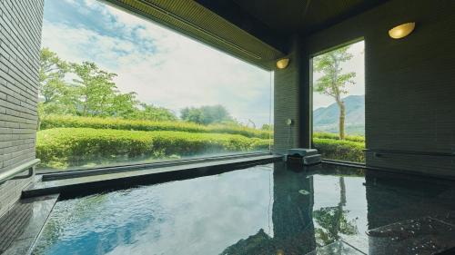 a swimming pool in a house with a view at Fourtreat Hakone Sengokuhara in Hakone