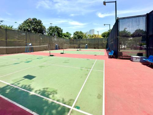 a tennis court with two tennis courts at Great Quality, Convenient To Airport Stu Apt In City Centre in Hanoi