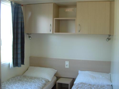 A bed or beds in a room at Mobilhome Angel