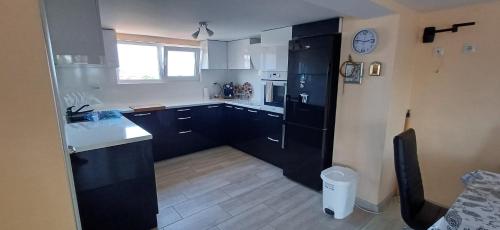 a kitchen with black cabinets and a white counter top at Lux Maisonette in Chernomorets