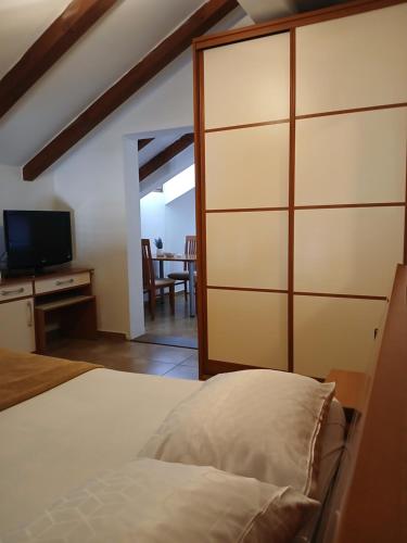 a bedroom with a large closet with a bed and a television at Gospar Apartments in Kotor