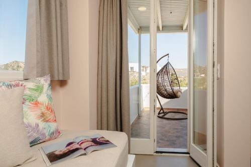 a living room with a couch and a glass door at Michaella Studios in Plaka
