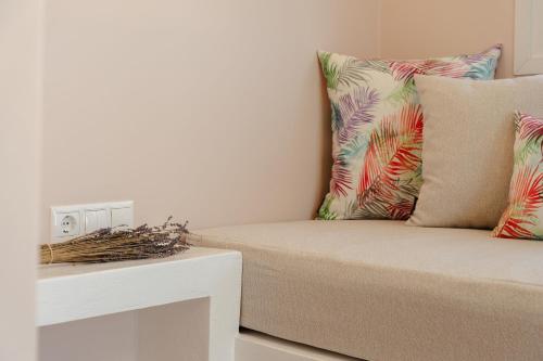 a living room with a couch with pillows at Michaella Studios in Plaka