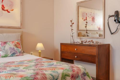 a bedroom with a bed and a dresser and a mirror at Michaella Studios in Plaka