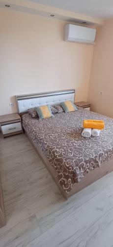 a bedroom with a large bed in a room at Lux Maisonette in Chernomorets