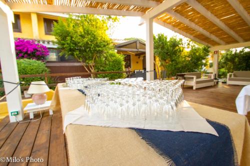 a group of wine glasses sitting on a table at Is Benas Country Lodge in San Vero Milis