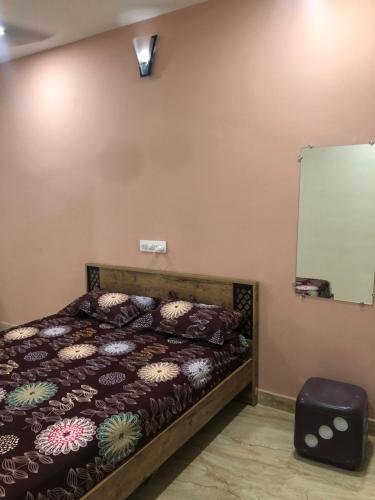 a bedroom with a bed and a chalkboard on the wall at Chinmayi Guest Suite in Avanigadda