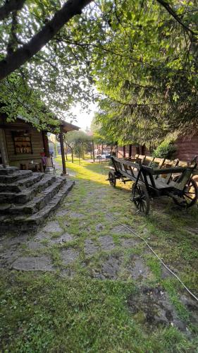 a couple of benches sitting next to a building at "Будиночок гедоніста" in Tukhlya