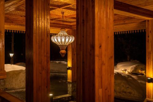 a room with a chandelier and a bed with snow at The Khyber Himalayan Resort & Spa in Gulmarg