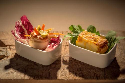 two bowls of food sitting on a table at Villa Hotel Valle Del Marta Resort in Tarquinia