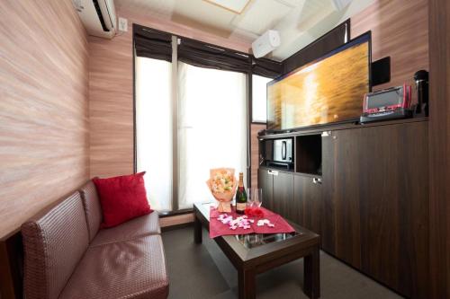 a small living room with a couch and a table at Hotel Opera in Tokyo