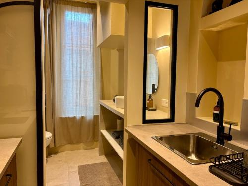a bathroom with a sink and a toilet and a mirror at Le George Ville in Nice