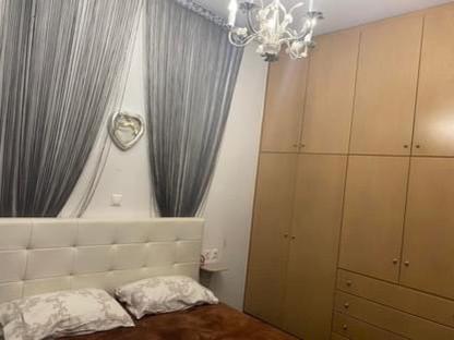 a bedroom with a bed and a window with curtains at Deep Blue in Korinthos