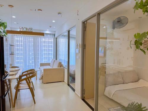 a living room with a bed and a table at Gạo's Homestay - The Song in Vung Tau