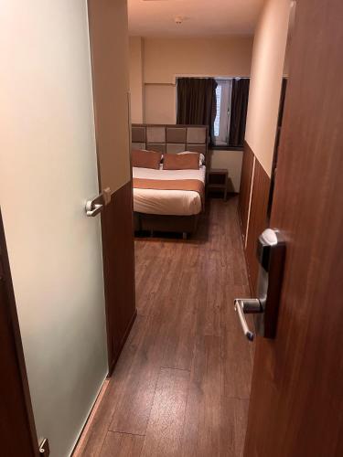 a room with a bedroom with a bed and a door at OZO Hotels Cordial Amsterdam in Amsterdam