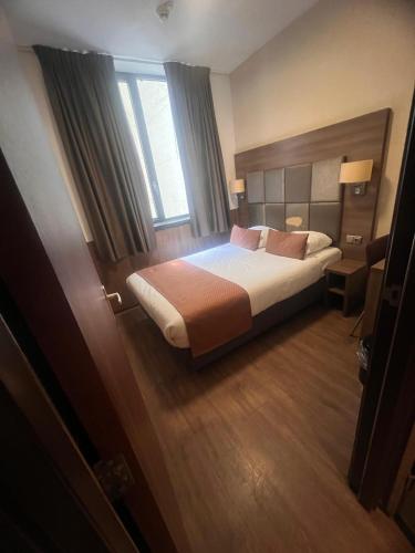 a hotel room with a bed and a window at OZO Hotels Cordial Amsterdam in Amsterdam