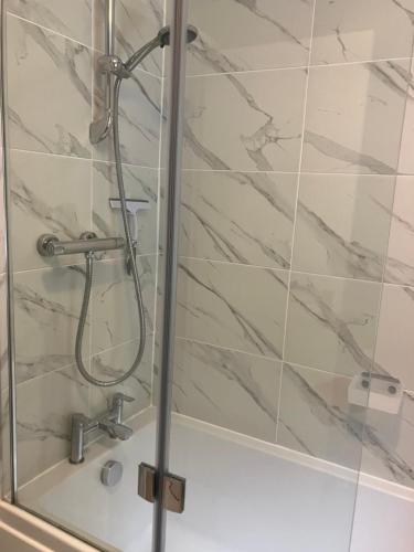 una ducha con puerta de cristal en un baño en 18 Wixon Path, en Buckinghamshire