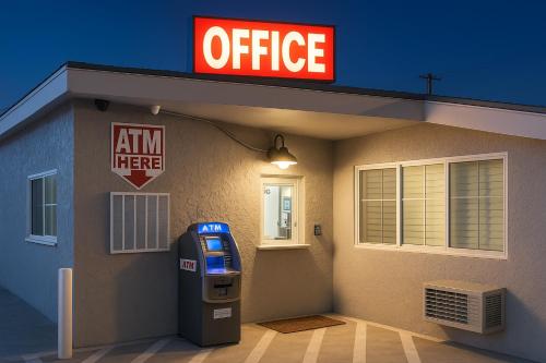 a gas station with an office sign and a parking meter at Sand Piper Motel - Los Angeles in Los Angeles
