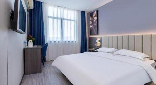 Ένα ή περισσότερα κρεβάτια σε δωμάτιο στο 7 Days Inn Luoyang Railway Station Wangcheng Avenue
