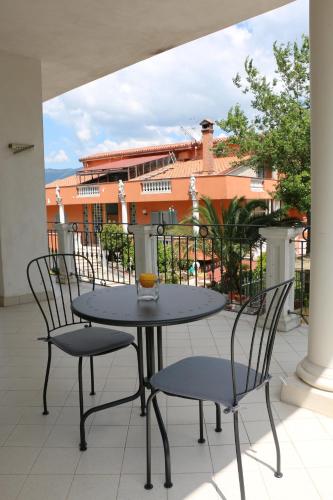 a table and chairs on a balcony with a building at B&B TENUTA BIANCA in Oliveto Citra