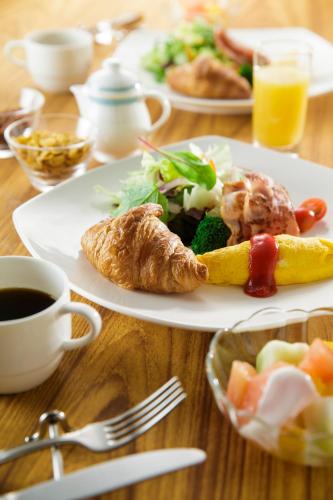 a table with a plate of food and a cup of coffee at ANA Holiday Inn Kanazawa Sky by IHG in Kanazawa