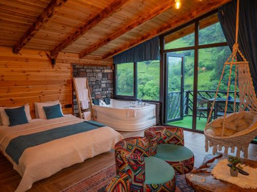 En eller flere senge i et værelse på Sisorti bungalow otel