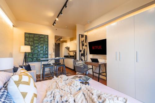 a living room with a bed and a dining room at Ivory Residences I Premium Apartment l Close to Malls I Downtown I Managed by Bleuspace in Davao City