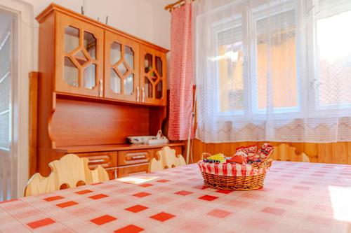 a kitchen with a table with a basket on it at Sárga ház a Kék úton - Becske in Becske