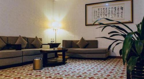 a living room with a couch and a table at Manhatton Hotel Beihai in Beihai