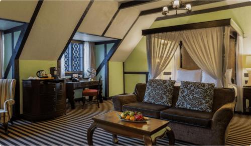 a living room with a couch and a bed and a desk at The Lakehouse Cameron Highlands in Ringlet